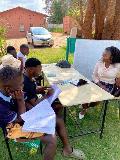 May be an image of one or more people, people studying and text